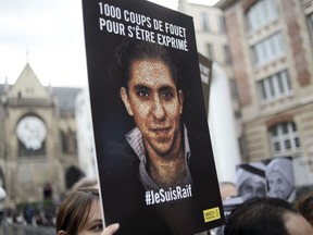 People demonstrate in support of Raif Badawi, who was sentenced to 1,000 lashes for "insulting Islam, on May 7, 2015 in Paris. The case of Badawi, 31, has sparked worldwide outrage and criticism from the United Nations, United States, the European Union, Canada and others.  Badawi co-founded with Suad al-Shammari the Saudi Liberal Network Internet discussion group. He was arrested in June 2012 under cybercrime provisions, and a judge ordered the website shut after it criticised Saudi Arabia's notorious religious police. Badawi was initially sentenced to seven years in jail and 600 lashes for insulting Islam and setting up the liberal network. AFP PHOTO / STEPHANE DE SAKUTIN
