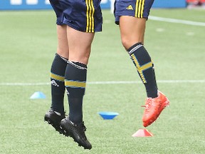 Team Sweden women's soccer players Mimmi Lowfenius (left) & Malin Diaz jump during practice on Sunday. (BRIAN DONOGH/Winnipeg Sun)
