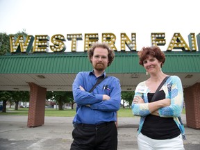 Benjamin Vazquez of the East London Historical Society and Sandra Miller of the Architecture Conservancy of Ontario do not want this Western Fair sign torn down. The old sign is to be replaced by a sign that looks old. (DEREK RUTTAN, The London Free Press)