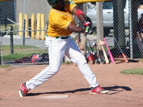 Felix Septimo of the Kanata Athletics takes a cut at the ball during the first game of a double-header against the Kingston Ponies in Kingston on Saturday. (Steph Crosier/The Whig-Standard)