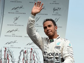 Lewis Hamilton, who held the lead from the first turn on, waves to the crowd after his Canadian Grand Prix victory on Sunday. (AFP/PHOTO)