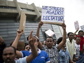 Eritrean refugees hold placards during a protest against the Eritrean government outside their embassy in Tel Aviv, Israel May 11, 2015. Eritrea regards anyone who tries to leave the country as a traitor, but a large portion of the population has already fled. About 6 to 10% of Eritreans are now registered as refugees by the UN. REUTERS/Baz Ratner
