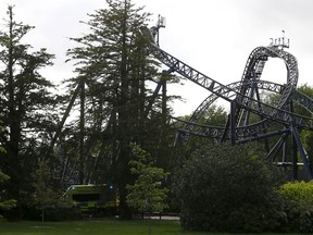 An ambulance drives past the Smiler ride at Alton Towers in Alton, Britain June 2, 2015. Four teenagers were seriously hurt at one of Britain's biggest theme parks when two carriages collided on a roller-coaster ride. One victim has had her left leg amputated as a result.  REUTERS/Darren Staples