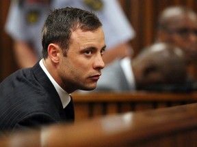 This file photo taken on September 12, 2014 shows South African Paralympic athlete Oscar Pistorius listening to the verdict in his murder trial in the High Court in Pretoria, where he was found guilty of culpable homicide. Oscar Pistorius, the South African double amputee sprinter who shot dead his girlfriend, is scheduled to be freed on parole on August 21, 2015 after serving ten months in jail, officials said on June 8, 2015.  (AFP PHOTO / POOL / SIPHIWE SIBEKO)