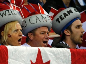 Canadian fans cheer for their team during the gold medal wheelchair curling competition at the 2014 Sochi Paralympic Winter Games March 15, 2014. (REUTERS/Alexander Demianchuk)
