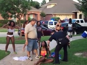 A police officer in McKinney, Texas, was suspended after he was caught on video wresting a girl to the ground and pulling his gun on teens. (YouTube/Screengrab)