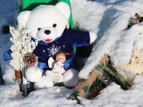 A teddy bear and flowers lay in the snow at a memorial for Russell Haidar in Potter Greens Park, near 925 Picard Dr. in Lewis Estates, Sunday Dec. 18, 2011. Haidar was fatally shot in the west Edmonton park Dec. 14, 2011. DAVID BLOOM EDMONTON SUN