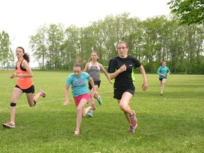 At St. Columban School's track and field day May 29, grades 7 and 8 girls ran the 100-metre dash. Pictured from left are Amber Rock, Ally O'Rourke, Sydney Yost and Rebecca Klaver. GALEN SIMMONS/MITCHELL ADVOCATE