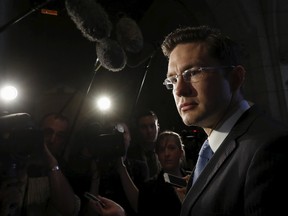 Canada's Employment and Social Development Minister Pierre Poilievre speaks to journalists on Parliament Hill in Ottawa May 27, 2015. REUTERS/Chris Wattie