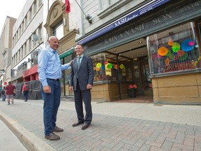 London Music Hall owner Mike Manuel, left, jokes with Nash Jewellers owner Colin Nash outside the downtown Dundas St. shop. (CRAIG GLOVER, The London Free Press)