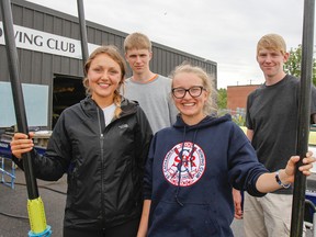 Kingston Collegiate rowers, from left, Alex Wiley, Liam Strong, Sophia Linton and Robert Cadman pose for a photo outside the Kingston Rowing Club on Monday. The four made it to their respective pairs finals at the Canadian Secondary School Rowing Association championships in St. Catharines on the weekend. (Julia McKay/The Whig-Standard)