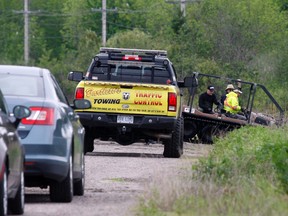 North Bay police, the coroner's office and a forensic anthropologist use an all-terrain vehicle Monday to access a swamp where a shoe and remains were discovered. Police will remain on site for a few days to complete a ground search of the area.
Jennifer Hamilton-McCharles / Postmedia Network