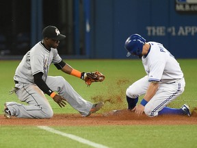 Toronto Blue Jays centre fielder Kevin Pillar (11) slides safely into second with a stolen base ahead of the tag from Miami Marlins shortstop Adeiny Hechevarria (3) Monday at Rogers Centre. (Dan Hamilton/USA TODAY Sports)