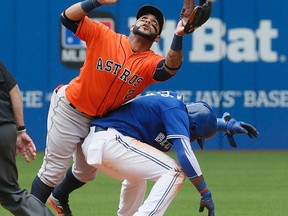 Houston Astros shortstop Jonathan Villar tries to get around Jose Reyes on second base, but can't get to a ball hit by Jose Bautista in the ninth inning at the Rogers Centre in Toronto on June 7, 2015. (STAN BEHAL/Toronto Sun)