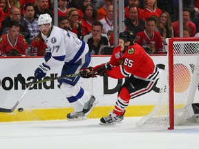 Tampa Bay Lightning defenceman Victor Hedman (77) battles for the puck with Chicago Blackhawks centre Andrew Shaw during Game 3 of the Stanley Cup final Monday at United Center. (Dennis Wierzbicki/USA TODAY Sports)