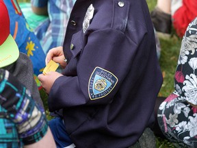 St. Elizabeth Grade 1 student Adam Allaer is all smiles as he gets to try on a Chatham-Kent Police Service hat on during a career day presentation at the school on June 5.