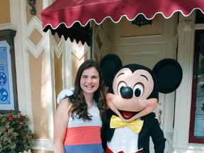 Grace MacNaull, 12, hangs out with Disney’s main man, Mickey Mouse, to mark six decades of Disneyland. STEVE MACNAULL PHOTO