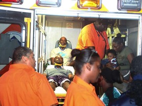 Survivors of a single-engine plane crash arrive by ambulance at the Coral Harbour Base in the Bahamas on June 8, 2015. (REUTERS/Royal Bahamas Defence Force/Handout)