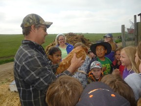 Jeff Hammond shows a laying hen to the students.