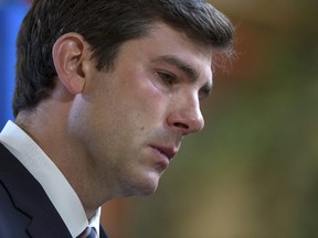 Edmonton Mayor Don Iveson sheds a tear while speaking to reporters about the death of police officer Const. Daniel Woodall. REUTERS/Topher Seguin