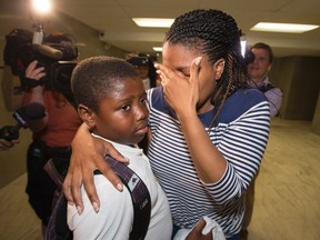 Tyler Cadougan, 8, reunites with his mom after being missing for hours on Tuesday, June 9, 2015. (Craig Robertson/Toronto Sun)