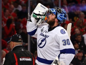 Ben Bishop #30 of the Tampa Bay Lightning takes a drink during a break in play against the Chicago Blackhawks during Game Three of the 2015 NHL Stanley Cup Final at the United Center on June 8, 2015 in Chicago, Illinois.  )Bruce Bennett/Getty Images/AFP)