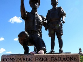 Blossoms are left on the Ezio Farone statue in Edmonton , Alberta on Tuesday June 9, 2015. FILE PHOTO