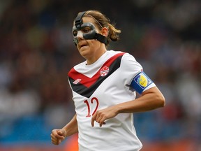 Christine Sinclair, seen here wearing a mask to protect her broken nose, in action during the 2011 Women's World Cup in Germany. (Ina Fassbender/Reuters/Files)
