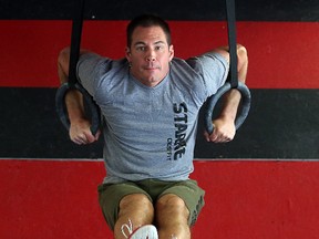 Paul Dyck, owner of Starke Strength and Conditioning, works out on Olympic rings at his gym in Winnipeg.