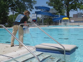 Personnel from Strathroy’s Parks and Recreation department cleans the pool at the Strathroy Fair Grounds Recreation Complex. This facility will be used by the municipality to run its summer camp program. File photo.