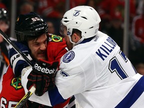 Andrew Shaw (left) of the Chicago Blackhawks and Alex Killorn of the Tampa Bay Lightning get involved in a scuffle after the whistle during Game 3 of the Stanley Cup final Monday at the United Center in Chicago. (Bruce Bennett/Getty Images/AFP)