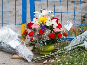 Flowers are seen at the fatal shooting of Const. Dan Woodall at 18620 62A Ave. on Tuesday. (Ian Kucerak/Edmonton Sun)