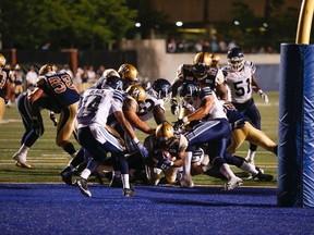 Winnipeg Blue Bombers Cameron Marshall, RB (32) scores the winning touchdown on a two-yard dive in the fourth quarter. Blue Bombers defeat the Argos 34-27 during CFL pre-season action in Toronto, Ont. at Varsity Stadium on Wednesday June 10, 2015. Jack Boland/Toronto Sun/Postmedia Network