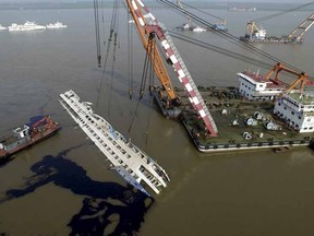 An aerial view of rescuers working on righting the capsized cruise ship Eastern Star, in Jianli, Hubei province, China, June 5, 2015. The death toll from a Chinese cruise ship that capsized on the Yangtze River climbed to 97 on Friday as authorities righted the battered vessel and turned their efforts to recovering bodies still on board amid simmering anger from distraught families. REUTERS/Stringer