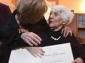 Retired German neonatologist Ingeborg Syllm-Rapoport (R) aged 102, is congratulated by an unidentified woman as she poses with her doctoral certificate at the UKE hospital in Hamburg, June 9, 2015. From 1937 until 1938 Syllm-Rapoport studied medicine in Hamburg, but the admission to her oral exam was denied by the Nazi authorities due to her Jewish origin. Some 77 years later Syllm-Rapoport took her oral exam and passed it successfully on May 20, 2015. REUTERS/Fabian Bimmer