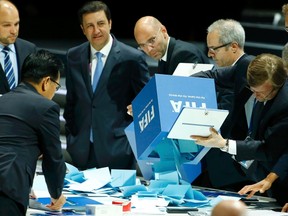FIFA staff empty ballot boxes after the first round of the election to decide the organization's presidency at the 65th FIFA Congress in Zurich, Switzerland, May 29, 2015. (REUTERS/Ruben Sprich)