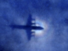 The shadow of a Royal New Zealand Air Force (RNZAF) P-3 Orion maritime search aircraft is seen on low-level cloud, as it flies over the southern Indian Ocean looking for missing Malaysia Airlines Flight MH370, in this March 31, 2014 file photo. (REUTERS/Rob Griffith/Pool/Files)
