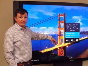 Brian Eskridge of Microsoft's devices business marketing team demonstrates a Surface Hub business conferencing gear at the US technology titan's office in San Francisco on June 5, 2015.  (AFP PHOTO/GLENN CHAPMAN)