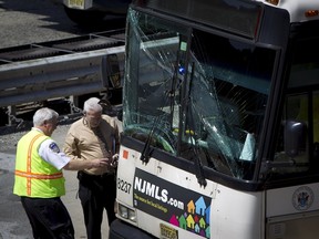 Officials work near a bus that was involved in Lincoln Tunnel crash on Wednesday, June 10, 2015. (REUTERS)