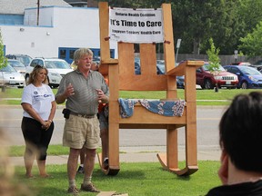 Peter Boyle, a volunteer with the Ontario Health Coalition, speaks outside Vision Nursing Home in Sarnia Wednesday during a stop on the coalition's Giant Rocking Chair Tour. The tour is hitting 24 Ontario municipalities to talk about ways to improve Ontario's nursing homes. (Tyler Kula, The Observer)