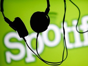 Headsets hang in front of a screen displaying a Spotify logo on it, in Zenica Feb. 20, 2014.  REUTERS/Dado Ruvic