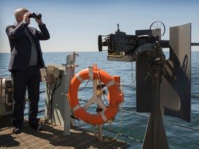 Canada's Prime Minister Stephen Harper views Russian naval vessels while on board the Canadian frigate HMCS Fredericton in the Baltic Sea, June 10, 2015. (REUTERS/PMO/Jason Ransom/Handout)