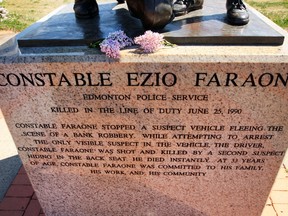 Blossoms are left on the Ezio Farone statue in Edmonton , Alberta on Tuesday June 9, 2015. Perry Mah/Edmonton Sun/Postmedia Network