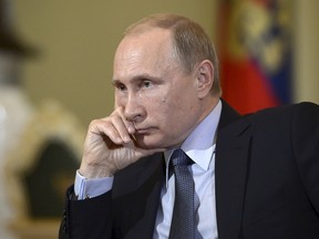 Russian President Vladimir Putin attends an inteview with journalists of Italian newspaper Corriere della Sera in Moscow, Russia, May 28, 2015. Russia fully backs the Minsk peace agreements in Ukraine, but progress is being stalled by Kiev, Russian President Vladimir Putin said in an interview in Italian newspaper Corriere della Sera on Saturday. Picture taken May 28, 2015. REUTERS/Aleksey Nikolskyi/RIA Novosti/Kremlin