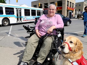 Louise Bark, a former Kingston resident, is involved in an Ontario Human Rights Tribunal case against the City of Kingston over public transit accessibility issues. Bark was in Kingston with her service dog Bruce on Wednesday. (Ian MacAlpine/The Whig-Standard)