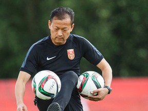 chines head coach Hao Wei figures the teams in Group A are fairly even, and it's up to his team to determine whether they will advance to the next stage. (Ian Kucerak, Emdonton Sun)