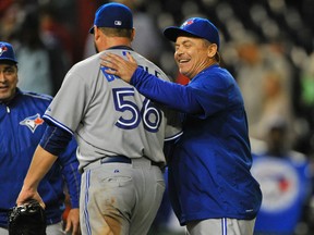 Toronto Blue Jays manager John Gibbons congratulates starting pitcher Mark Buehrle after his complete-game win over the Washington Nationals at Nationals Park on June 3, 2015. Buehrle allowed only one walk in the nine innings. The victory was the second win of the Blue Jays' winning streak, which was extended to eight games on June 10. (TOMMY GILLIGAN/USA TODAY Sports files)