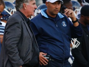 Toronto Argos head coach Scott Milanovich (right) talks with general manager Jim Barker in the first half of their team's CFL pre-season game against the Winnipeg Blue Bombers on June 9, 2015, at Varsity Stadium in Toronto. (JACK BOLAND/Toronto Sun)