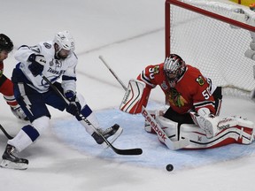 Chicago Blackhawks goalie Corey Crawford (50) defends the goal as Tampa Bay Lightning centre Alex Killorn (17) attempts a shot during Game 4 of the Stanley Cup final Wednesday at United Center. (David Banks/USA TODAY Sports)
