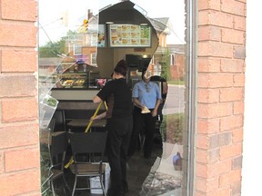 Staff at the Tim Hortons on Third Street in Chatham clean up after a deer jumped through a window on Thursday morning.